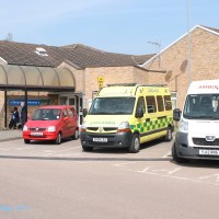 Ambulance and red car parked outside Grantham hospital entrance