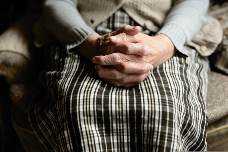 old woman with hands in her lap